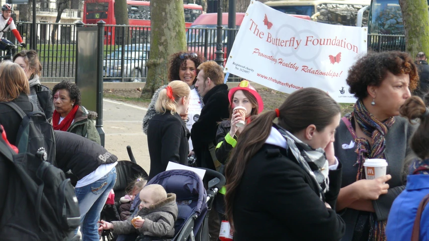 a group of women with a sign that says the family foundation