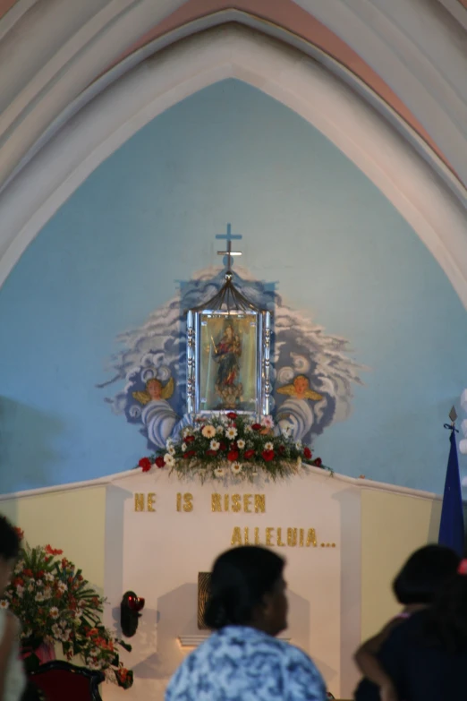 the inside of a church, with a cross in the middle