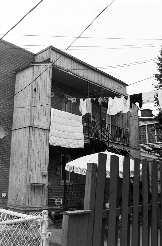 a building with laundry hanging outside by an electric fence