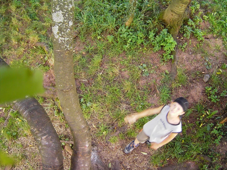 a boy on a bike near a tree