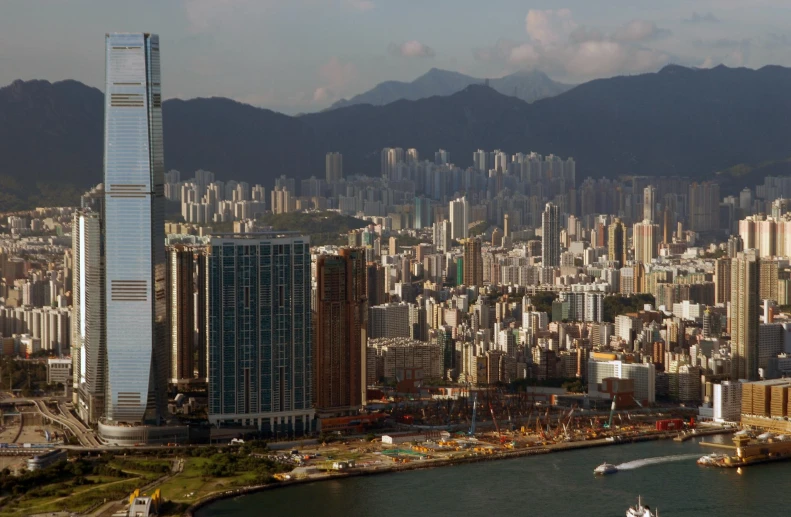 a city in the middle of a river with mountains behind it