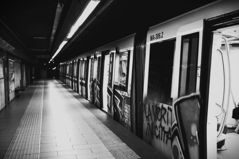 subway train with graffiti on it at the station