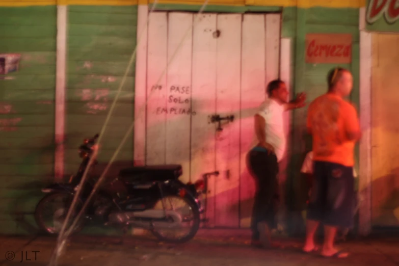 a couple of men standing outside of a store door