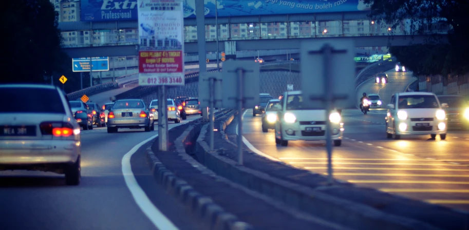 many cars driving on the highway during dusk