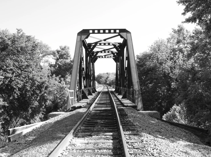 train tracks going down one track through the trees