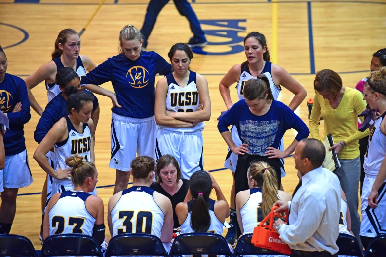 girls in the huskes talk together during the game