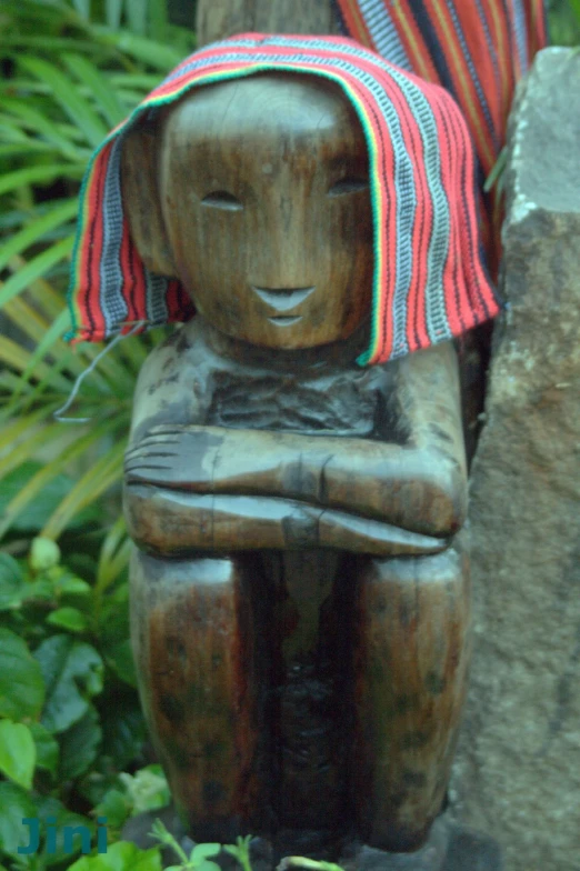 an animal statue with a striped hat on it