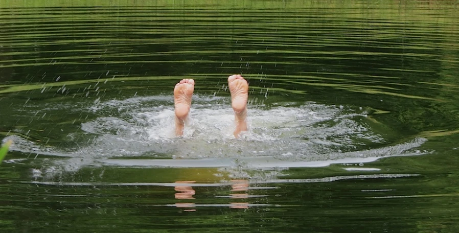 two feet are seen submerged in the water