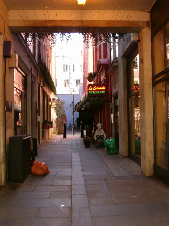 an empty street with shops and a neon sign that says the town is closed