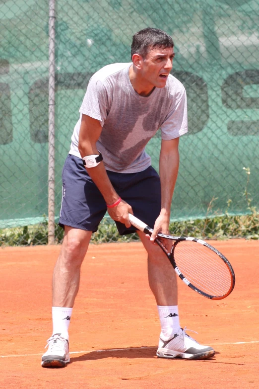 a man is holding a tennis racket while playing