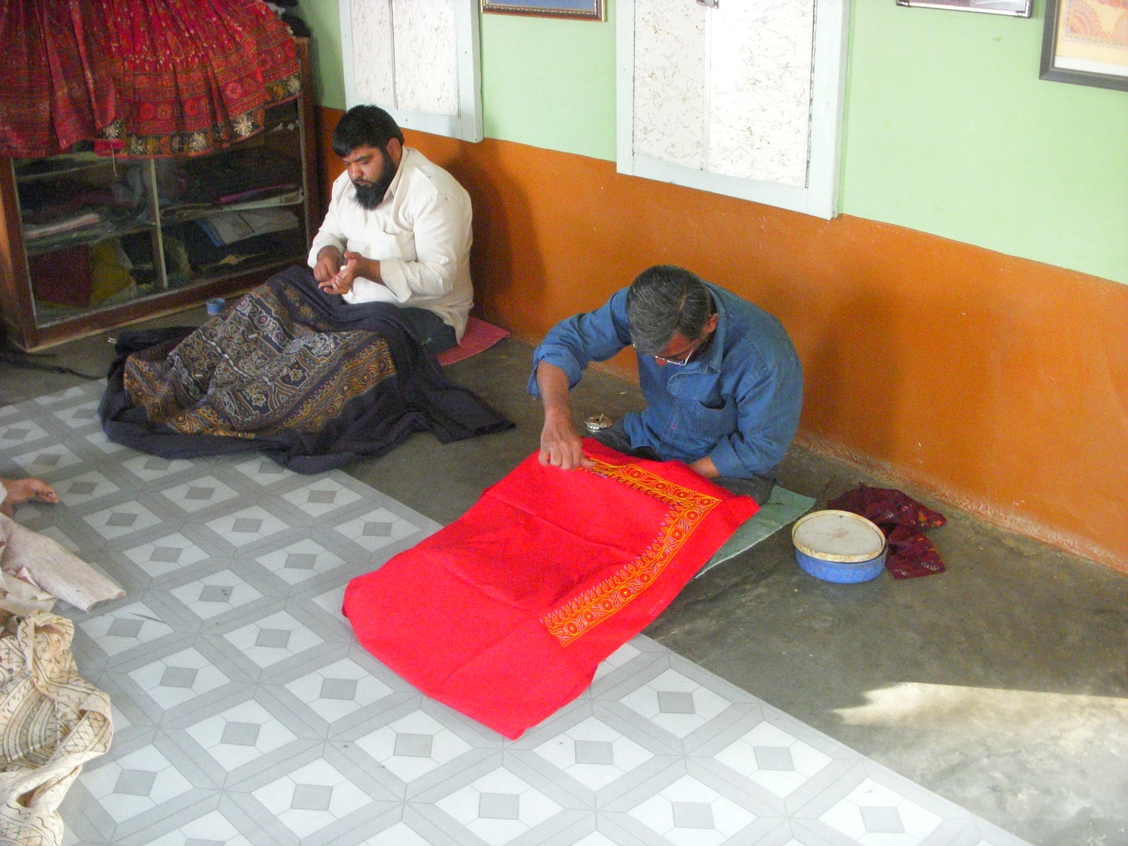 two men who are sitting on the ground