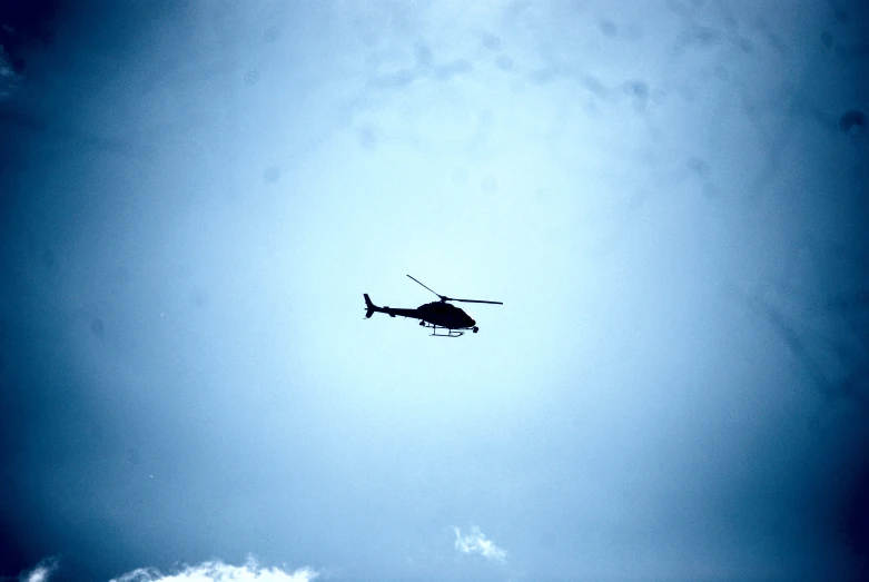 a helicopter is flying low in the sky