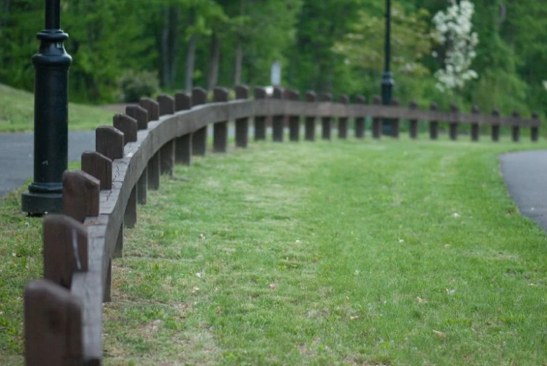 there is a park path and bench in the grass