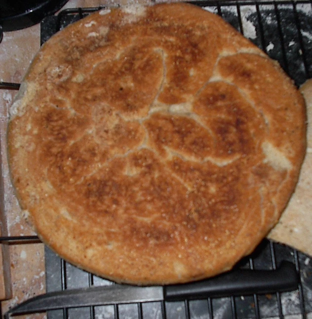 a table with a baked item that is on top