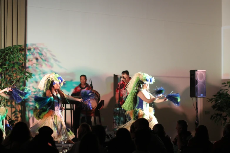 several dancers performing on stage with some onlookers