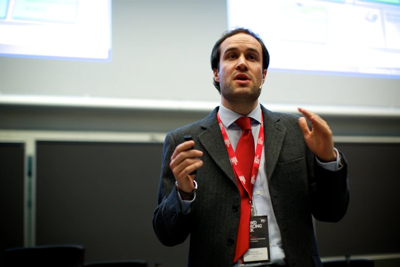 a man in a suit talking while standing