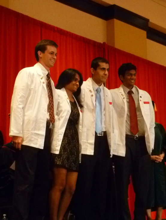 group of young men standing side by side and dressed in suits