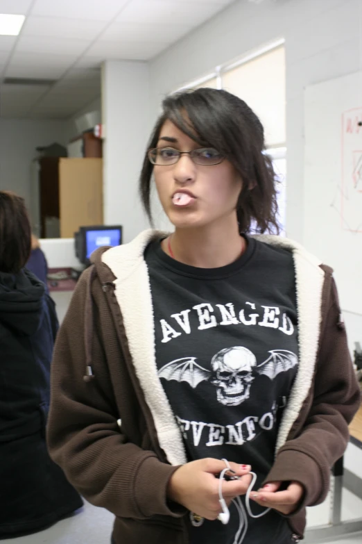 a girl in glasses holding a controller and smoking