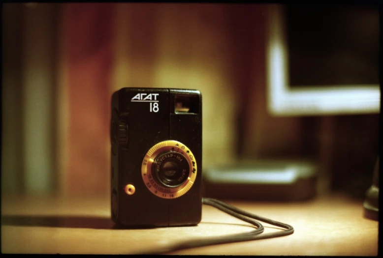 a vintage camera is laying on a desk