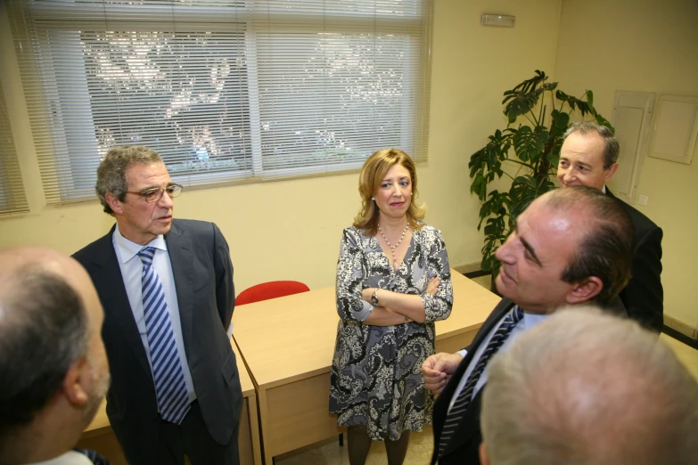 people are gathered in an office building waiting to meet with one another