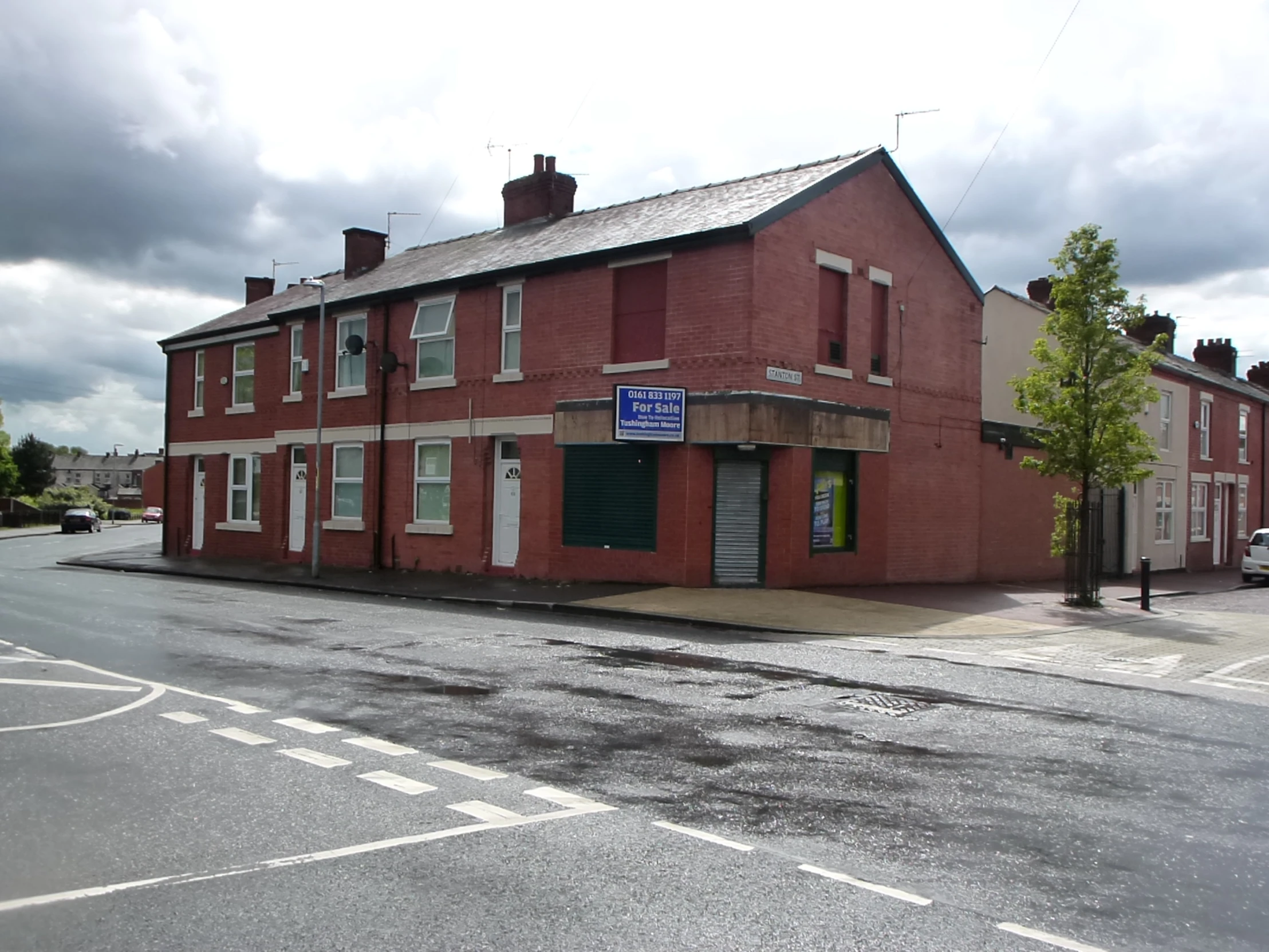 a red brick building with two windows and doors