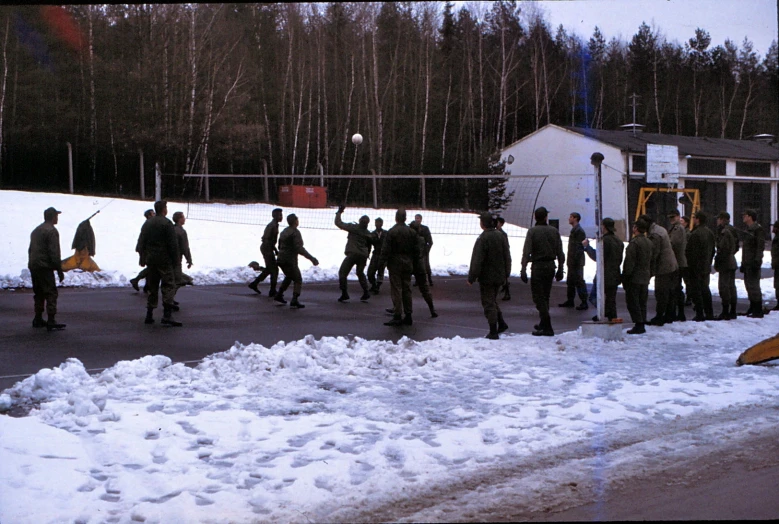 a group of people standing outside in the snow