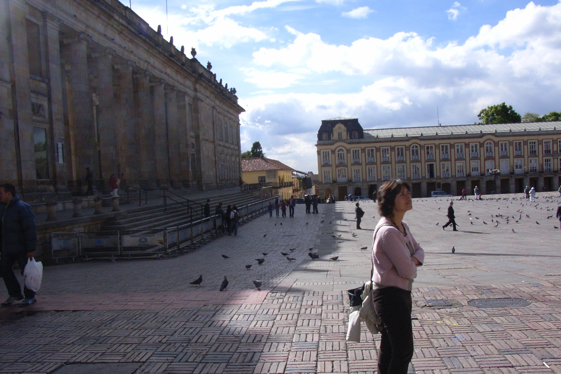 people walking around outside a large building