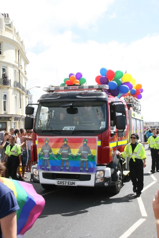 people standing around the parade with the colorful van