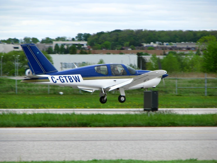 the small plane is flying low to the ground