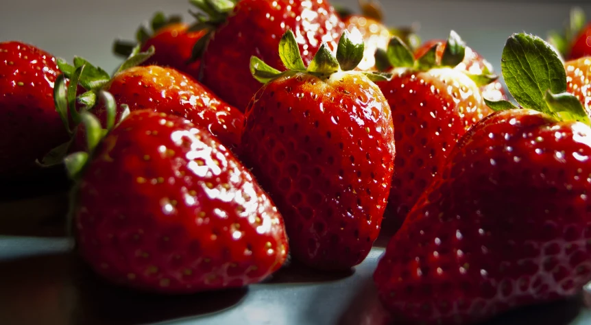 seven strawberries that have been placed in an arrangement