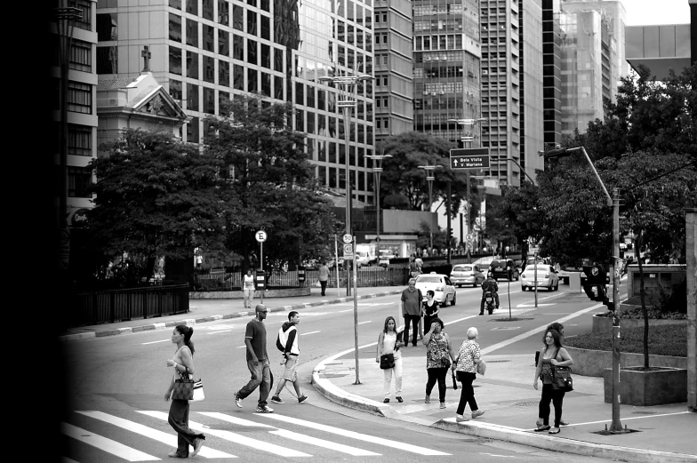 pedestrians walk across the street in a city