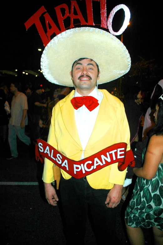 man in costume wearing sombrero and name sash at event