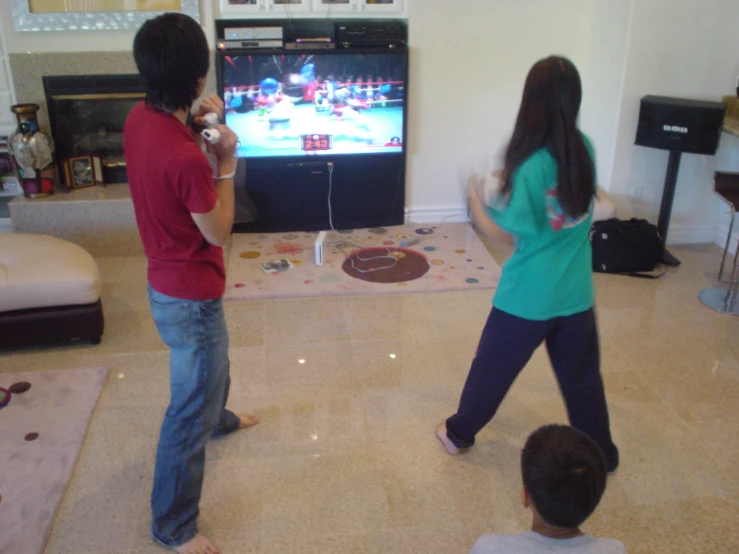 two people playing a video game in front of a tv