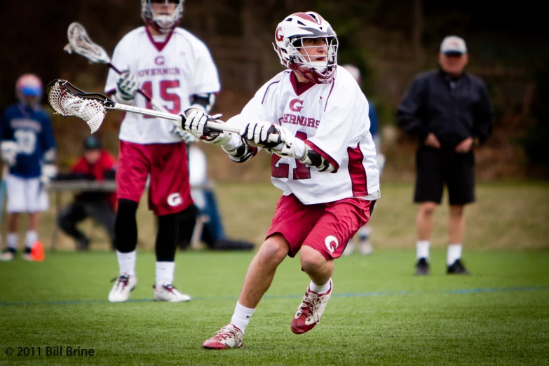 an image of some men playing lacrosse on the field