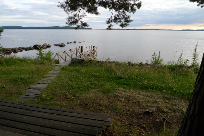 a path going through a grassy area next to water