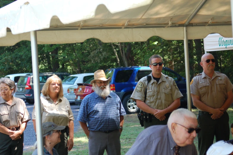 a group of people standing under a tent