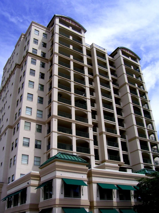 a el building with an awning and a blue sky background