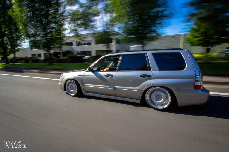 the car is driving down the road in the street