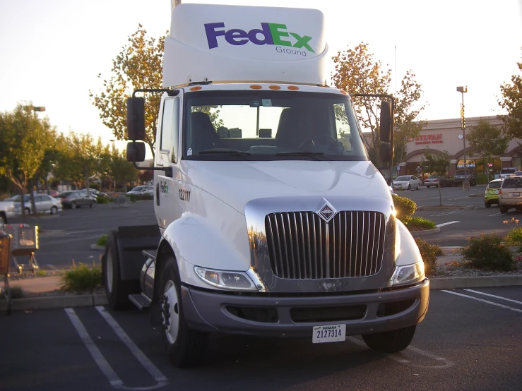 the delivery truck is parked in a large parking lot