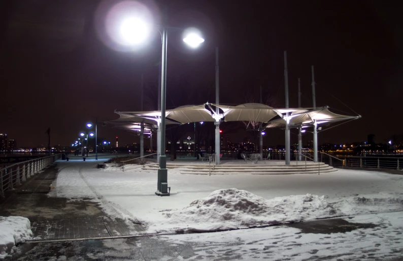 there is snow on the ground and some light poles