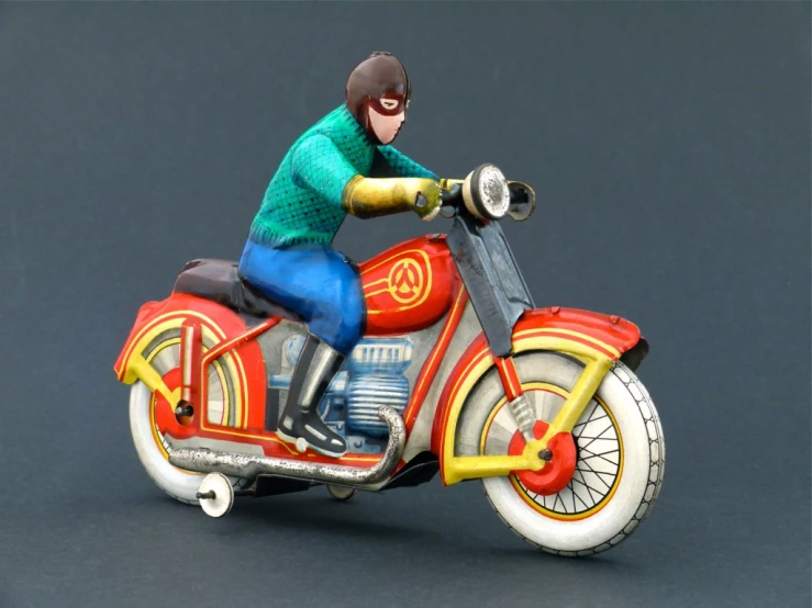 a toy motorcycle with a man riding on the seat