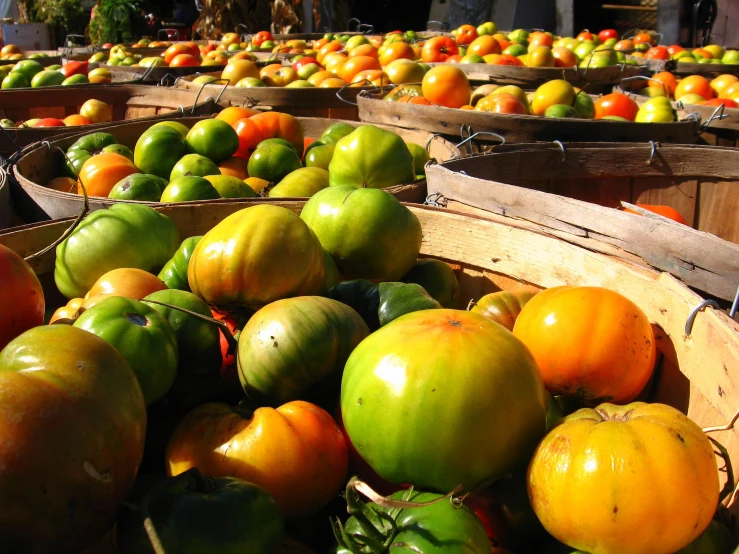 a pile of colorful fruits sitting in wooden baskets