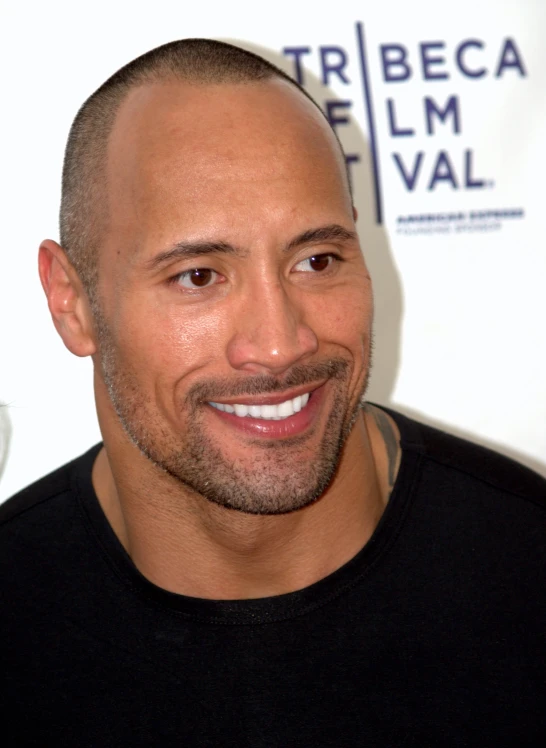 a man wearing a black shirt is smiling for the camera