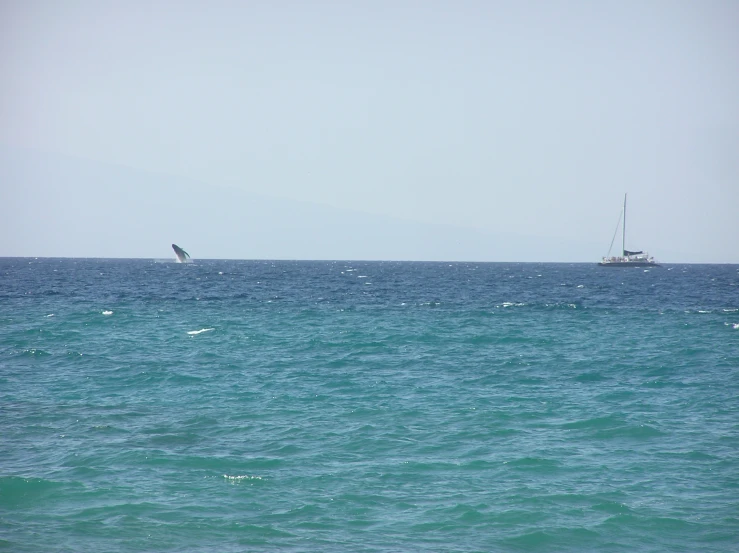 two boats out in the open water on an overcast day