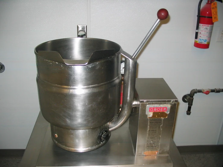 a large metal bucket sitting on top of a silver table