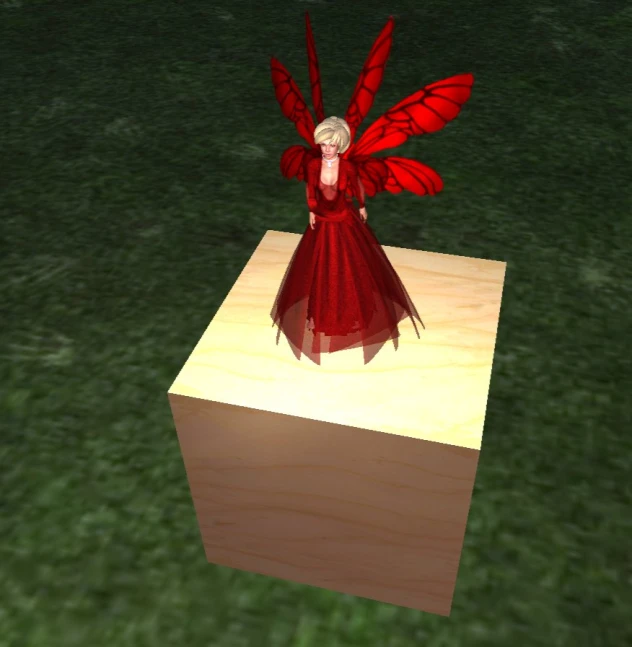 a woman standing in a red dress on top of a block