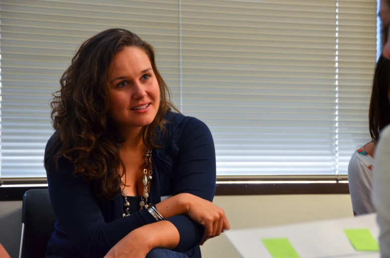 a woman looking ahead in an office setting