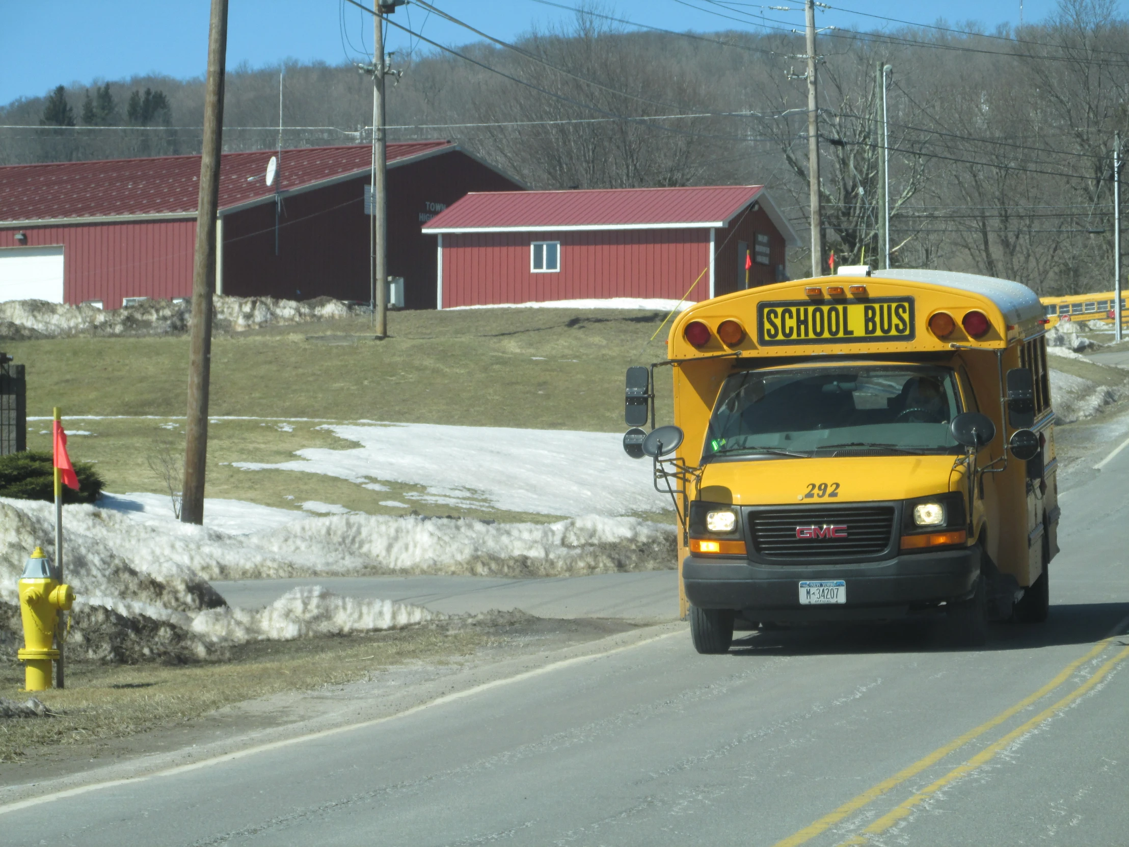 a school bus driving down a snowy road