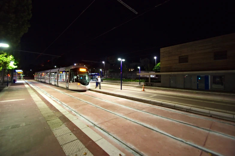 two trains sitting next to each other at night