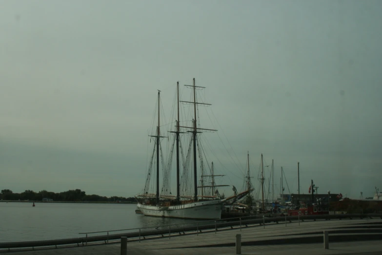 a boat docked near the dock on a cloudy day